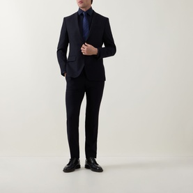 Model wearing Hugo Boss Dark Blue Single Cuff Regular shirt, styled with a navy suit, blue tie, and black leather shoes.