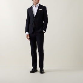 Model wearing Hugo Boss Joe Classic Shirt in white with navy suit, white pocket square, and black leather shoes