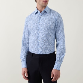 Model wearing Hugo Boss light blue floral print slim fit single cuff shirt, styled with navy trousers.