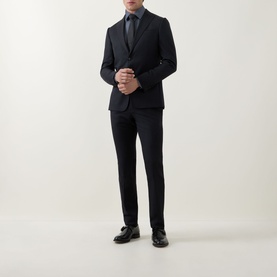 Model wearing Hugo Boss Hank Dark Blue Performance Stretch Shirt, styled with a navy suit, tie, and black leather shoes.