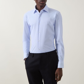 Model wearing Hugo Boss Hank Performance-Stretch Shirt in light blue, slim fit with Kent collar, long sleeves and single cuff, styled with black