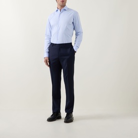 Model wearing Hugo Boss Light Blue Cotton Single Cuff Regular Shirt with navy tailored trousers and black dress shoes.
