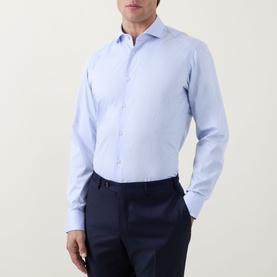 Model wearing Hugo Boss light blue single cuff regular fit formal shirt in 100% cotton, styled with navy trousers.