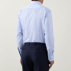 Model wearing Hugo Boss light blue cotton formal shirt, single cuff regular fit, styled with navy trousers. Rear view.