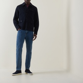 Model wearing Hugo Boss Orange Bright Blue straight jeans, styled with a navy shirt jacket and dark canvas trainers.