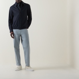 Model wearing Hugo Boss Orange Open Grey straight jeans, styled with a navy zip-up jacket and white trainers.