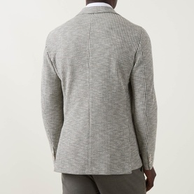 Model wearing Hugo Boss Hanry Houndstooth Single-Breasted Blazer in Open Green, back view showing double vents and houndstooth pattern