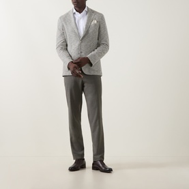 Model wearing Hugo Boss Hanry Houndstooth Single-Breasted Blazer in Open Green, styled with khaki trousers and brown leather shoes.