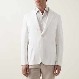 Model wearing Hugo Boss Hanry Single-Breasted Suit Jacket in Open White with notched lapels and patch pockets, styled with a white shirt and beige