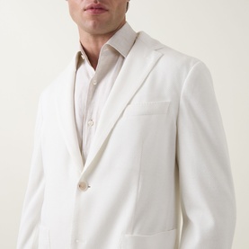 Model wearing Hugo Boss Hanry Single-Breasted Suit Jacket in Open White with notched lapels and chest pocket, styled with a beige shirt.