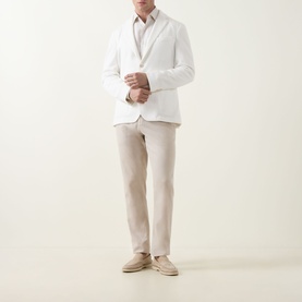 Model wearing Hugo Boss Hanry Single-Breasted Suit Jacket in Open White with notched lapels, styled with beige trousers and suede loafers