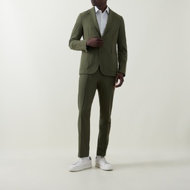 Model wearing Hugo Boss Hanry Single-Breasted Slim Blazer in Open Green with matching trousers, styled with a white shirt and white trainers.
