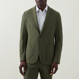 Model wearing Hugo Boss Hanry Single-Breasted Slim Blazer in Open Green, styled with matching trousers and white shirt