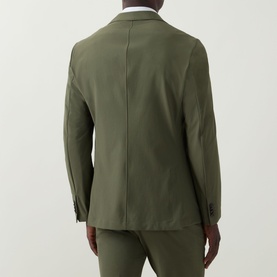 Model wearing Hugo Boss Hanry Single-Breasted Slim Blazer in Open Green, rear view, styled with matching trousers