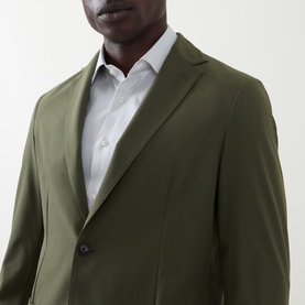 Model wearing Hugo Boss Hanry Single-Breasted Slim Blazer in Open Green, styled with a light grey shirt, close-up detail view
