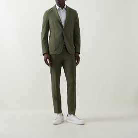 Model wearing Hugo Boss Hanry Single-Breasted Slim Blazer in Open Green with matching trousers and white trainers.