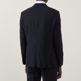 Model wearing Hugo Boss Houston Double-Breasted Suit Jacket in dark blue, rear view, styled with white shirt and dark trousers.