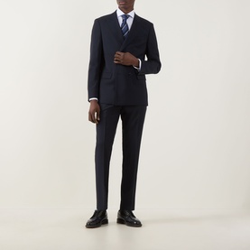 Model wearing Hugo Boss Houston Double-Breasted Suit Jacket in dark blue with matching trousers, styled with a blue tie and dark Oxford shoes.