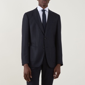 Model wearing Hugo Boss Hutson Single-Breasted Suit Jacket in dark blue wool, styled with white shirt and navy tie.