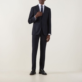 Model wearing Hugo Boss Hutson Single-Breasted Suit Jacket in dark blue, styled with matching trousers, white shirt, tie and black dress shoes