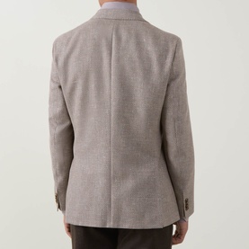 Model wearing Hugo Boss Hutson Single-Breasted Suit Jacket in medium beige, rear view showing double vents and button cuffs.