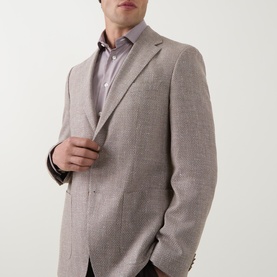Model wearing Hugo Boss Hutson Single-Breasted Suit Jacket in medium beige with notched lapels, styled with a lilac dress shirt.