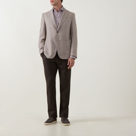 Model wearing Hugo Boss Hutson Single-Breasted Suit Jacket in medium beige, styled with dark trousers, striped shirt, and grey loafers