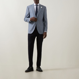 Model wearing Hugo Boss Janson Single-Breasted Suit Jacket in dark blue tonal check, styled with white shirt, navy tie and black trousers.