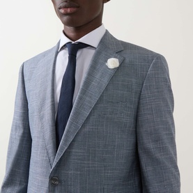 Model wearing Hugo Boss Janson Single-Breasted Suit Jacket in dark blue tonal check, styled with white dress shirt, navy tie, and white lapel pin.