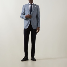 Model wearing Hugo Boss Janson Single-Breasted Suit Jacket in dark blue tonal check, styled with white shirt, navy tie and black trousers