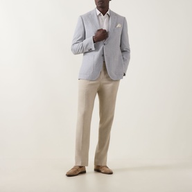 Model wearing Hugo Boss Open Grey cotton-wool suit jacket, styled with white shirt, beige trousers and tan suede loafers.
