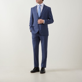 Model wearing Hugo Boss Jeckson Single-Breasted Two-Piece Suit in light pastel blue, styled with a light blue tie and black dress shoes.