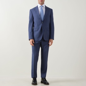 Model wearing Hugo Boss Jeckson Single-Breasted Two-Piece Suit in light pastel blue, styled with white shirt, blue tie and black leather shoes.
