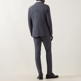 Model wearing Hugo Boss Huge Two-Piece Suit in light blue, rear view, styled with a white shirt and black leather shoes.