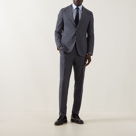 Model wearing Hugo Boss Huge Two-Piece Suit in light blue wool, styled with a white shirt, navy tie and black leather shoes