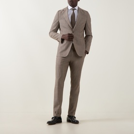 Model wearing Hugo Boss Huge Single-Breasted Two-Piece Suit in dark beige wool, styled with white shirt, grey tie and black loafers