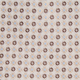 Close-up of cream fabric with repeating brown geometric floral and blue diamond pattern