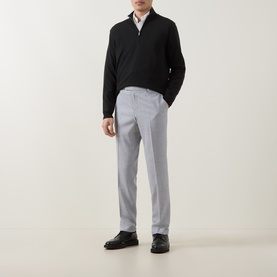 Model wearing Hugo Boss open grey trousers styled with a black half-zip jumper, white shirt, and black leather shoes.