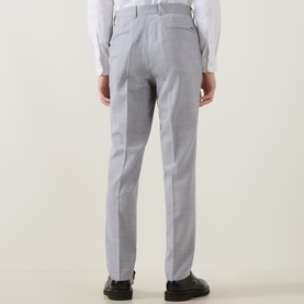 Model wearing Hugo Boss open grey tailored trousers, styled with a white shirt and black leather shoes, rear view.