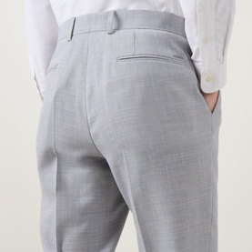 Model wearing Hugo Boss open grey tailored trousers, shown from rear, with welt back pocket detail and white shirt tucked in.