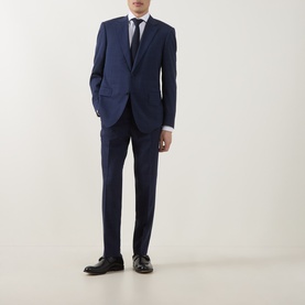 Model wearing Hugo Boss dark blue tailored trousers with matching suit jacket, white shirt, tie, and black leather shoes.