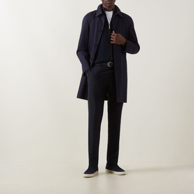Model wearing Hugo Boss Dark Blue wool-blend trousers, styled with navy overcoat, navy zip-neck top, white T-shirt, and grey slip-on shoes.