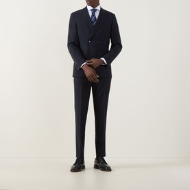Model wearing Hugo Boss George Slim-Leg Trousers in dark blue, styled with matching double-breasted blazer, blue tie, and black leather shoes.