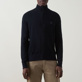 Model wearing Hugo Boss Orange dark blue cotton cashmere zip-through knit with tonal logo patch, styled with beige chinos.