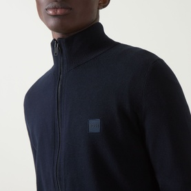 Model wearing Hugo Boss Orange dark blue cotton-cashmere zip-through knit with funnel neck and tonal logo patch on chest