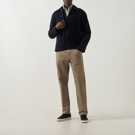 Model wearing Hugo Boss Orange dark blue cotton cashmere zip-through knit, styled with beige chinos and navy canvas shoes.
