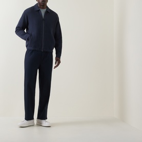 Model wearing Hugo Boss Orange Dark Blue zip-through sweat, styled with matching navy joggers and white trainers.