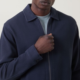 Model wearing Hugo Boss Orange dark blue cotton zip-through sweatshirt with collar, styled over a light grey crew-neck tee.