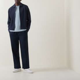 Model wearing Hugo Boss Orange Dark Blue zip-through sweat jacket with navy trousers, light blue tee and white trainers.