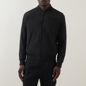 Model wearing Hugo Boss Orange black zip-through sweat jacket with ribbed collar, cuffs and hem, styled with black trousers.